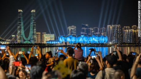 People gather at the promenade of Qiantang River to watch the light show ahead of the Asian Games in Hangzhou, China, on September 19.