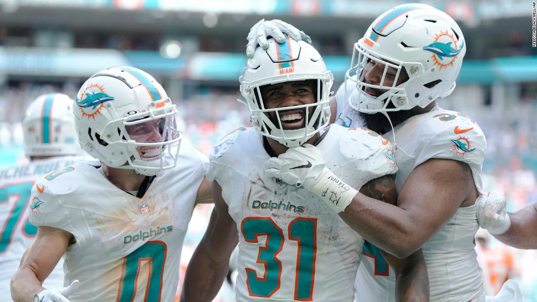 Miami Dolphins running back Raheem Mostert celebrates with teammates Braxton Berrios and Christian Wilkins after scoring one of his four touchdowns during the Dolphins&#39; landslide victory over the Broncos on Sunday, September 24. 