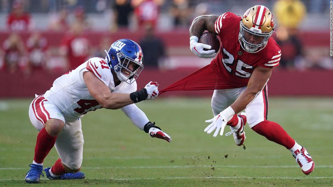 San Francisco 49ers running back Elijah Mitchell is tackled by New York Giants linebacker Micah McFadden in the second quarter at Levi&#39;s Stadium on September 24. The 49ers remain undefeated after their 30-12 Thursday Night Football win on September 21.