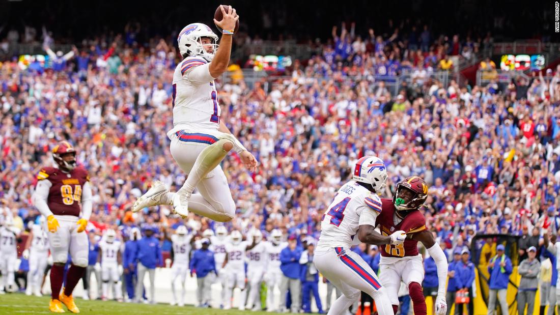 Buffalo Bills quarterback Josh Allen leaps into the end zone for a touchdown during his team&#39;s 37-3 win over the Washington Commanders on September 24. 