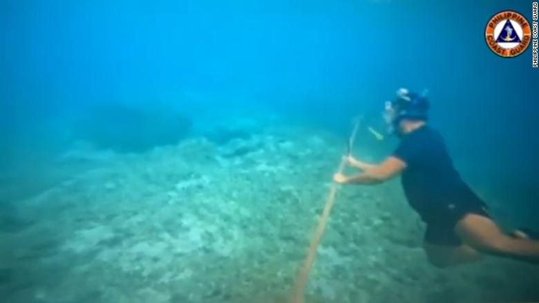 Video released of diver cutting China&#39;s floating sea barrier