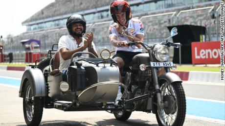 Repsol Honda&#39;s Spanish rider Marc Marquez (R) and India&#39;s former cricket player Suresh Raina ride on a motorbike ahead of the Indian MotoGP Grand Prix at the Buddh International Circuit in Greater Noida on the outskirts of New Delhi, on September 21, 2023.