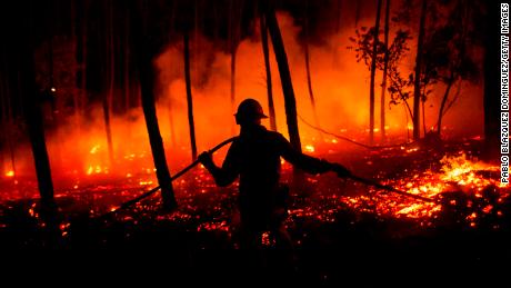 A firefighter battles a fire after wildfires took dozens of lives on June 19, 2017 near Pedrogao Grande, in Leiria district, Portugal. Some of the victims died inside their cars as they tried to flee the area. 