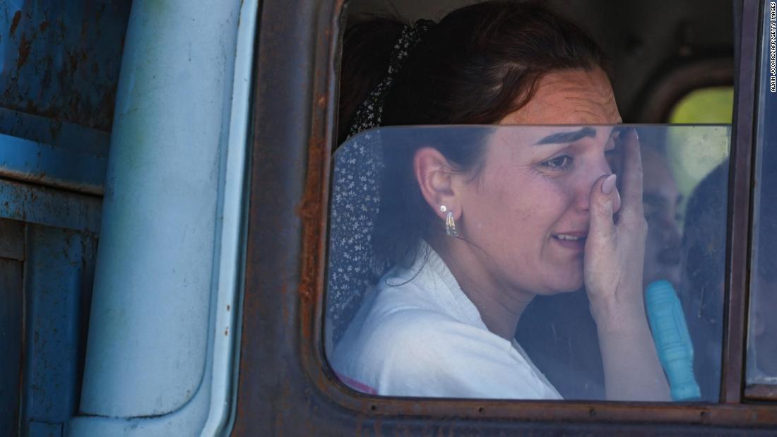 A woman cries after crossing the border near Kornidzor on September 27.