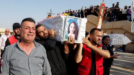 Mourners carry the coffin of a victim during a funeral in Hamdaniya, Iraq, on September 27.