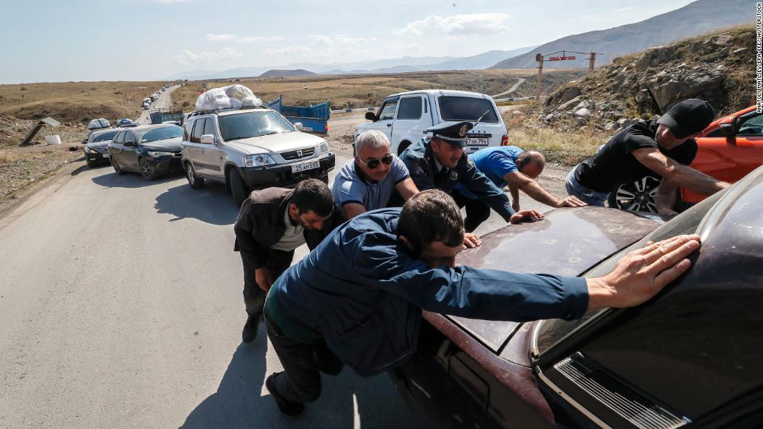 People help move a broken-down car near Kornidzor on September 28. 