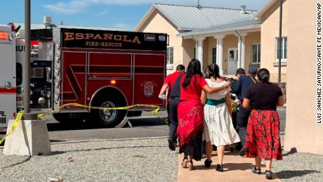 First responders arrive at the scene of a shooting Thursday, Sept. 28, 2023, in Española, N.M., where a protest over a statue of Spanish conquistador Juan de Oñate turned violent. A suspect was taken into custody after allegedly shooting and wounding a man at the protest Thursday, authorities said. (Luis Sánchez Saturno/Santa Fe New Mexican via AP)