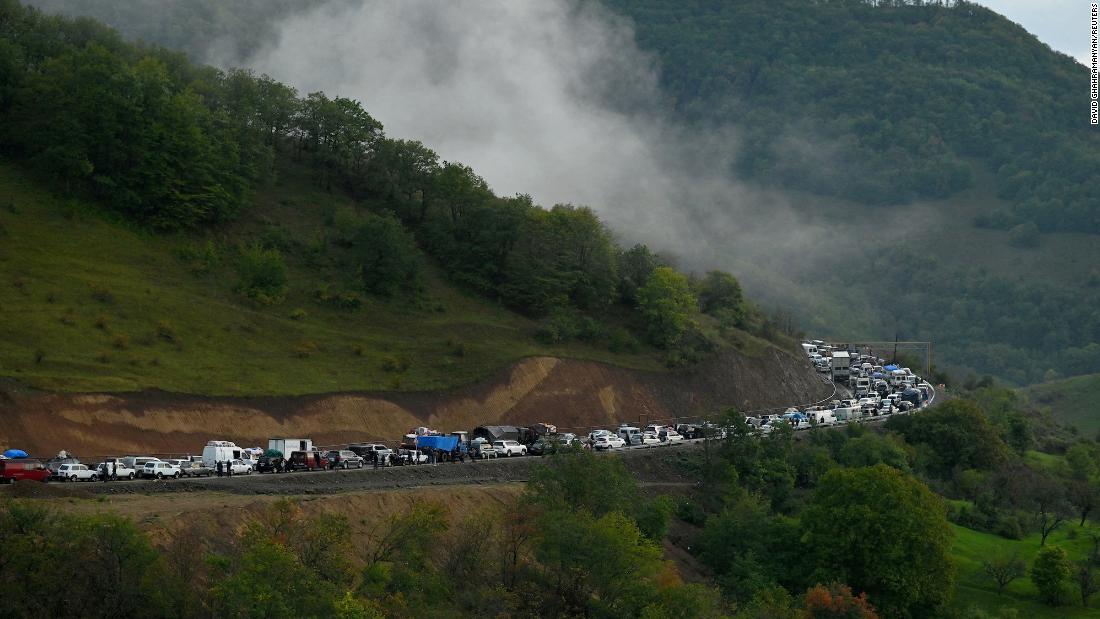 Vehicles carrying people leaving Nagorno-Karabakh queue on the road leading towards the Armenian border September 25.