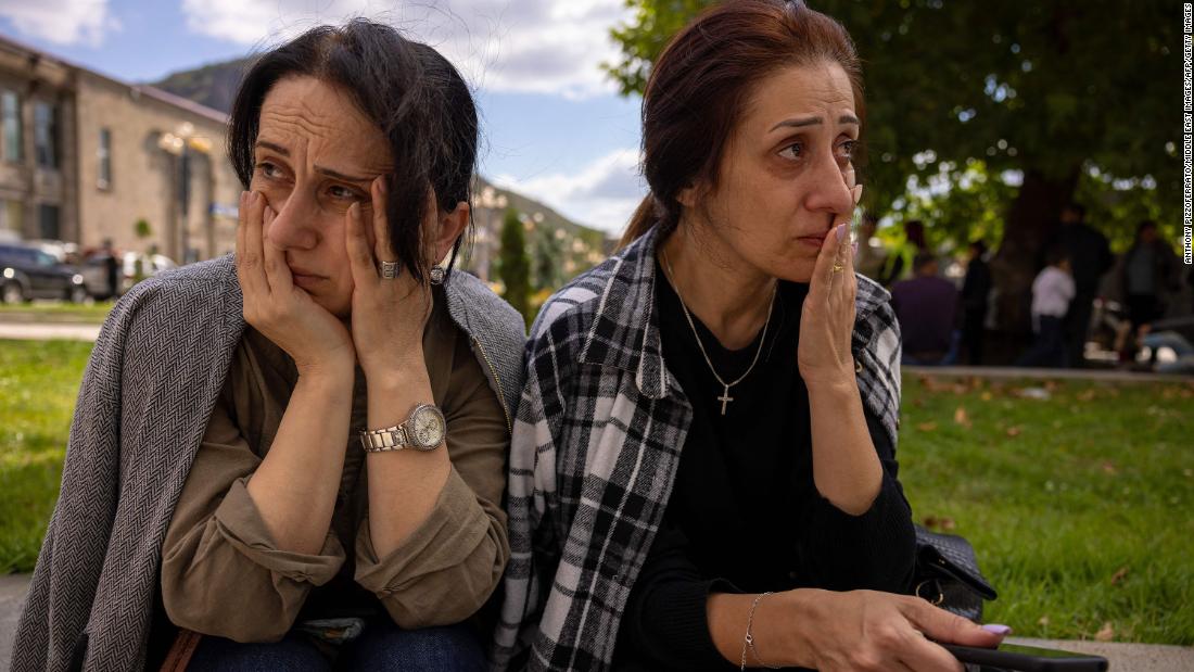 Greta and Marieta wait to reunite with relatives after arriving in Goris on September 27.