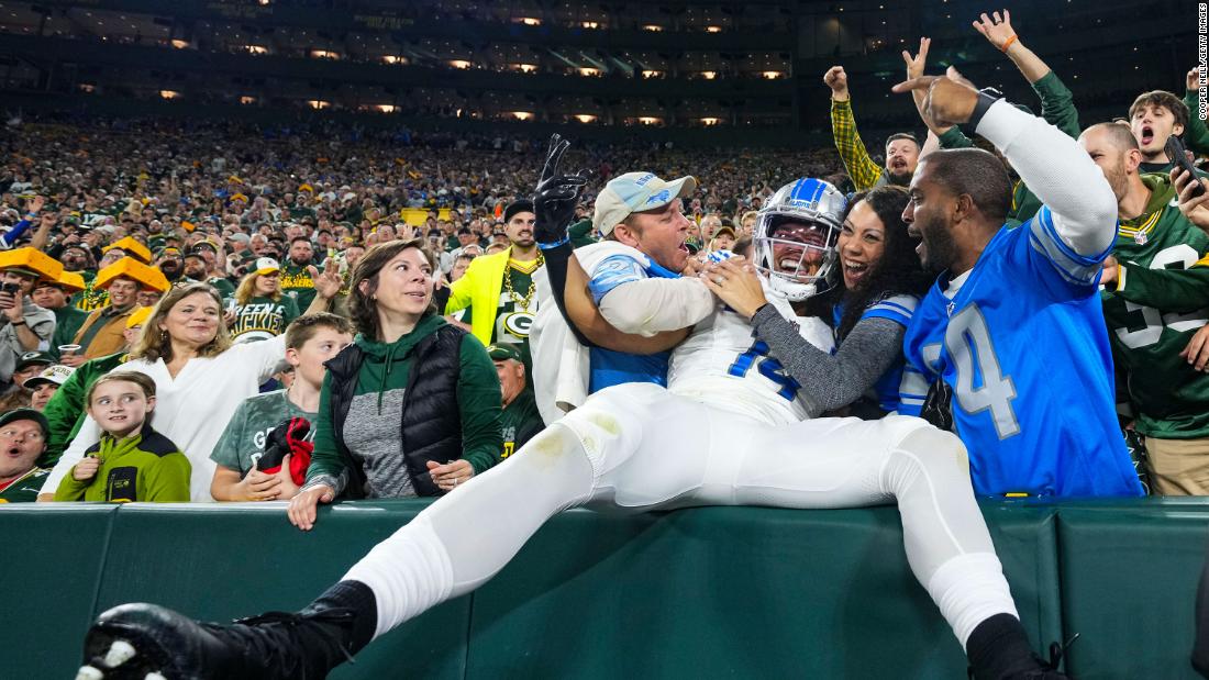 Amon-Ra St. Brown of the Detroit Lions celebrates with fans during his team&#39;s 34-20 victory over the Green Bay Packers at Lambeau Field on Thursday, September 28.