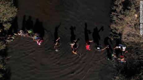 Migrants, who were stranded a day earlier near Villa Ahumada and who are seeking asylum in the United States, cross the Rio Bravo river, as seen from Ciudad Juarez in Mexico on September 30, 2023.
