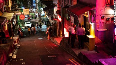 People on a night out in a once-bustling bar area of Hong Kong on October 5, 2023.
