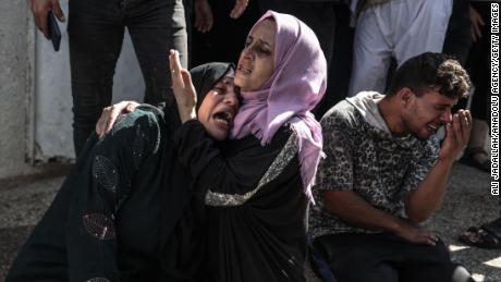  Relatives of Palestinians, killed by Israeli forces during airstrike clashes, mourn after they were taken to the morgue of Shifa Hospital in Gaza City.
