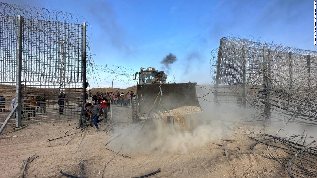 Palestinians break into the Israeli side of the Israel-Gaza border, after gunmen infiltrated parts of southern Israel on October 7.