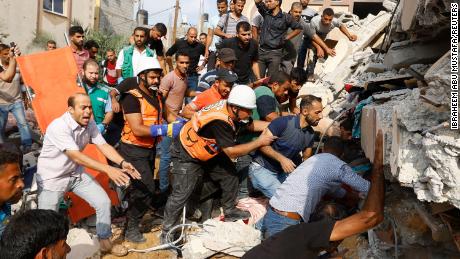 Palestinians search for casualties under the rubble of a house destroyed in Israeli strikes in Khan Younis, in the southern Gaza Strip.   