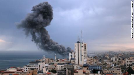 Smoke rises above buildings during an Israeli airstrike, in Gaza City on October 9.
