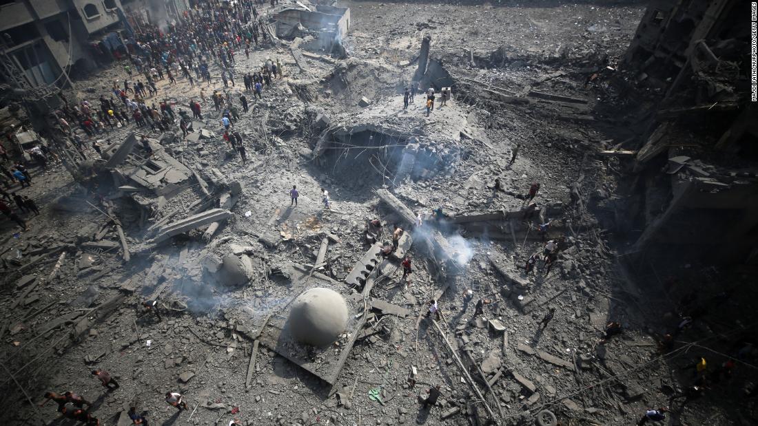 Palestinians inspect the damage following an Israeli airstrike on the Sousi mosque in Gaza City on October 9.