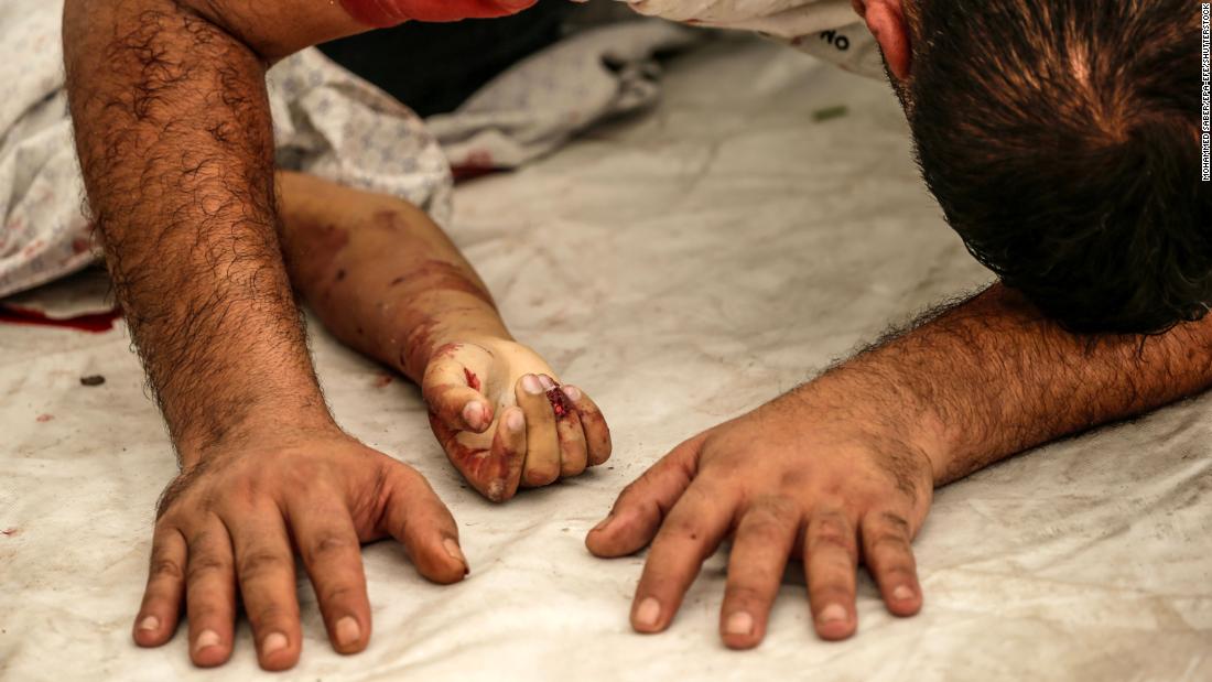 A Palestinian man mourns over the body of his nephew killed in an Israeli airstrike in Gaza City on October 9.