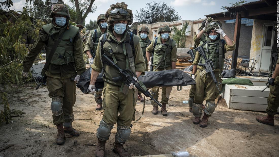 Israeli soldiers carry a body on October 10 in Kfar Aza, a village in Israel just across the border from Gaza. Hamas militants carried out a &quot;massacre&quot; in Kfar Aza during their attacks over the weekend, &lt;a href=&quot;https://www.cnn.com/middleeast/live-news/israel-hamas-war-gaza-10-10-23/h_7867b7563e54a0b29dddeada7e4c2722&quot; target=&quot;_blank&quot;&gt;the Israel Defense Forces told CNN&lt;/a&gt;.