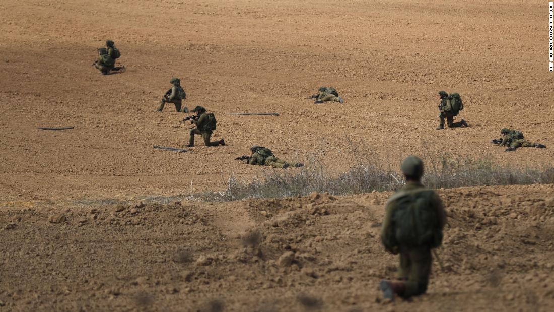 Israeli soldiers take position in Kfar Aza near the border with Gaza on October 10.