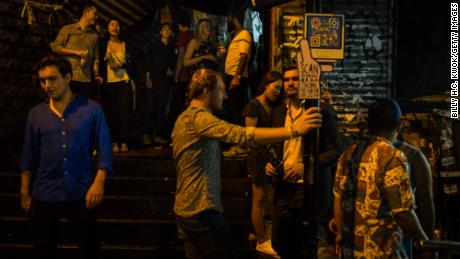 People stand and drink in Lan Kwai Fong in 2017, back when the place was still pumping.