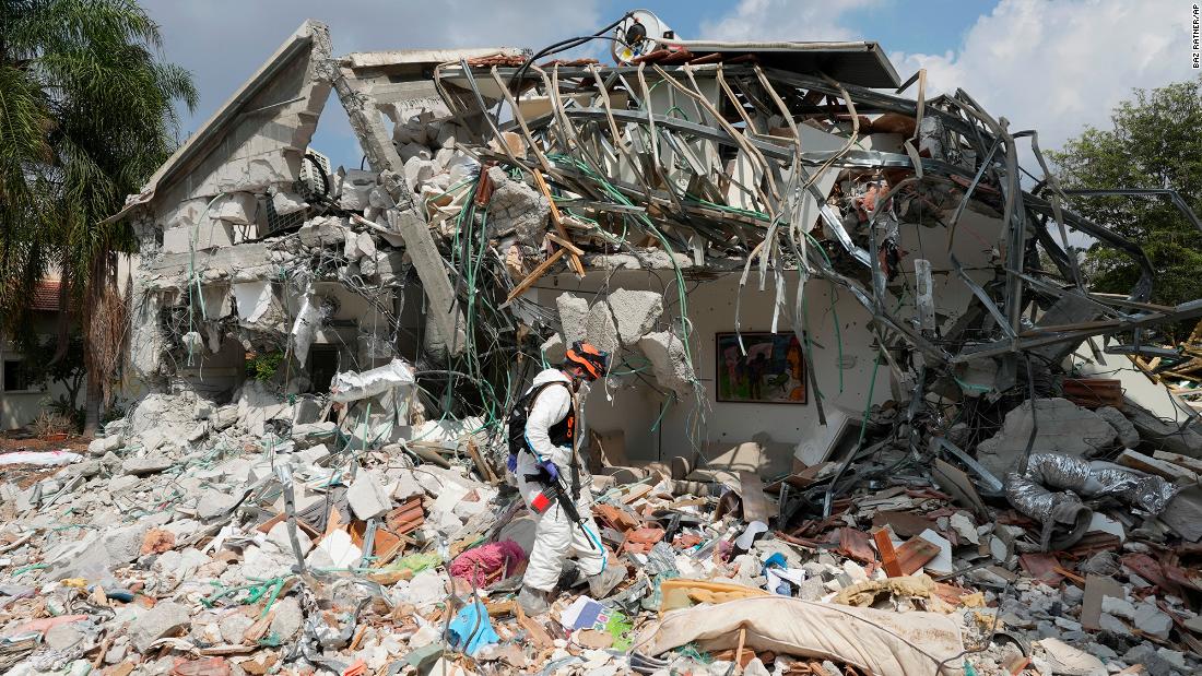 An Israeli soldier walks by a house destroyed by Hamas militants in Kibbutz Be&#39;eri on Wednesday, October 11.