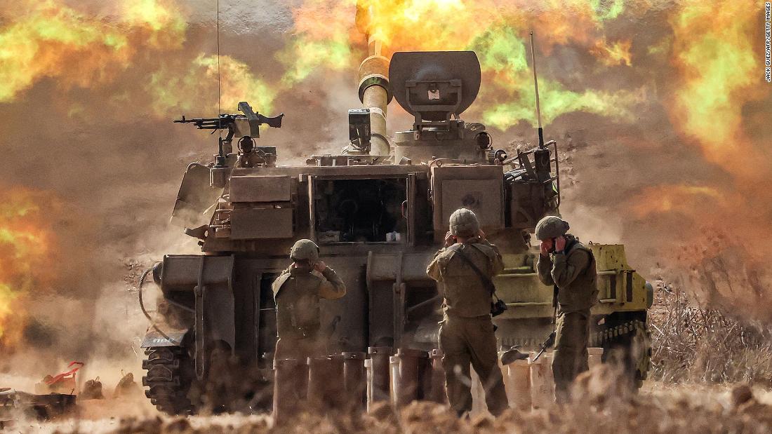 An Israeli army self-propelled howitzer fires rounds near the border with Gaza in southern Israel on October 11.