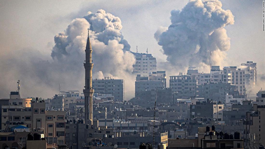 Smoke plumes billow during Israeli air strikes in Gaza City on October 12.