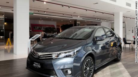 A Corolla Altis sedan stands on display at a Toyota Motor Corp. dealership in Singapore, on Tuesday, July 12, 2016. Buyers in one of the world&#39;s most expensive car markets just missed their chance to snag one at the cheapest price in five years. Car-ownership permit costs in Singapore have gained since February after ride-hailing companies obtained licenses for their fleets and the regulator eased rules on vehicle loans in May. Photographer: Ore Huiying/Bloomberg via Getty Images