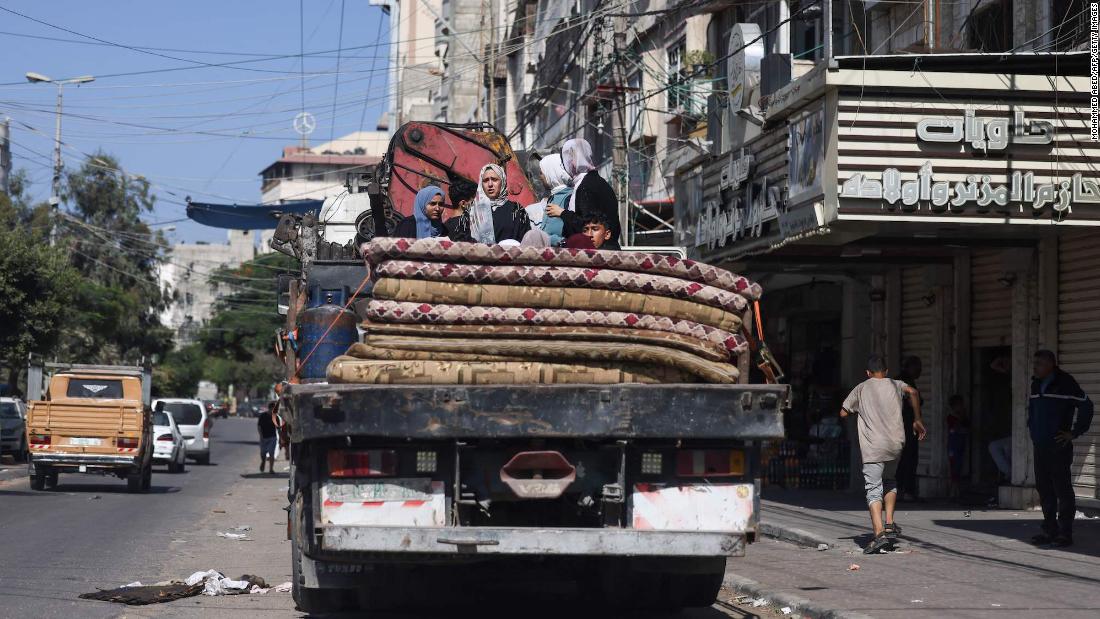 Tens of thousands flee south in bombarded Gaza as Israeli troops gather near border CNN.com – RSS Channel
