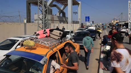 Palestinians with foreign passports arrive at the Rafah gate hoping to cross into Egypt as Israel&#39;s attacks on the Gaza Strip continues on October 14.. 