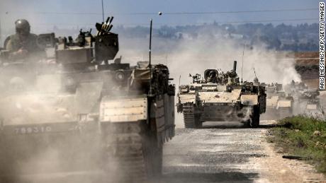 Israeli army Puma armored personnel carriers move in a column near the Gaza border in southern Israel on October 14, 2023. 