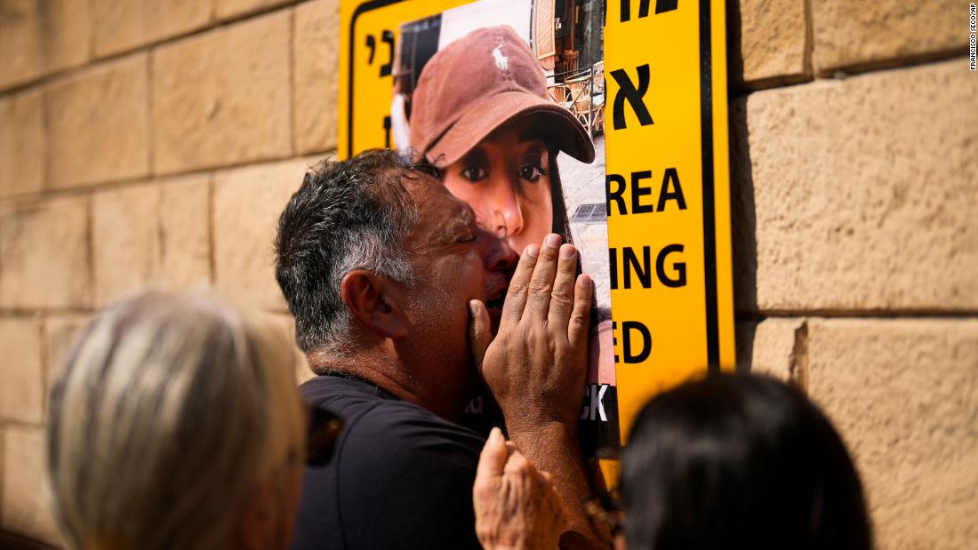 Eli Albag cries over the photograph of his daughter Liri, as he gathers with others during a protest demanding the release of more than 100 Israelis who were abducted during last week&#39;s Hamas attack, in Tel Aviv, Israel, on October 14.