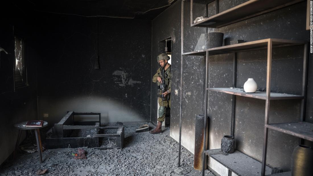 An Israeli soldier looks inside a house that was overrun by Hamas militants in Be&#39;eri, Israel, on October 13.