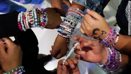 Teenagers trade bracelets while waiting for the beginning of Taylor Swift&#39;s Eras Tour concert movie in a cinema in Mexico City, Mexico October 13, 2023. 