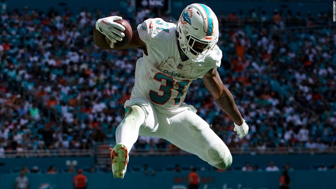 Miami Dolphins running back Raheem Mostert jumps over Carolina Panthers cornerback CJ Henderson on October 15. Mostert had two touchdowns during the Dolphins&#39; 42-21 victory.