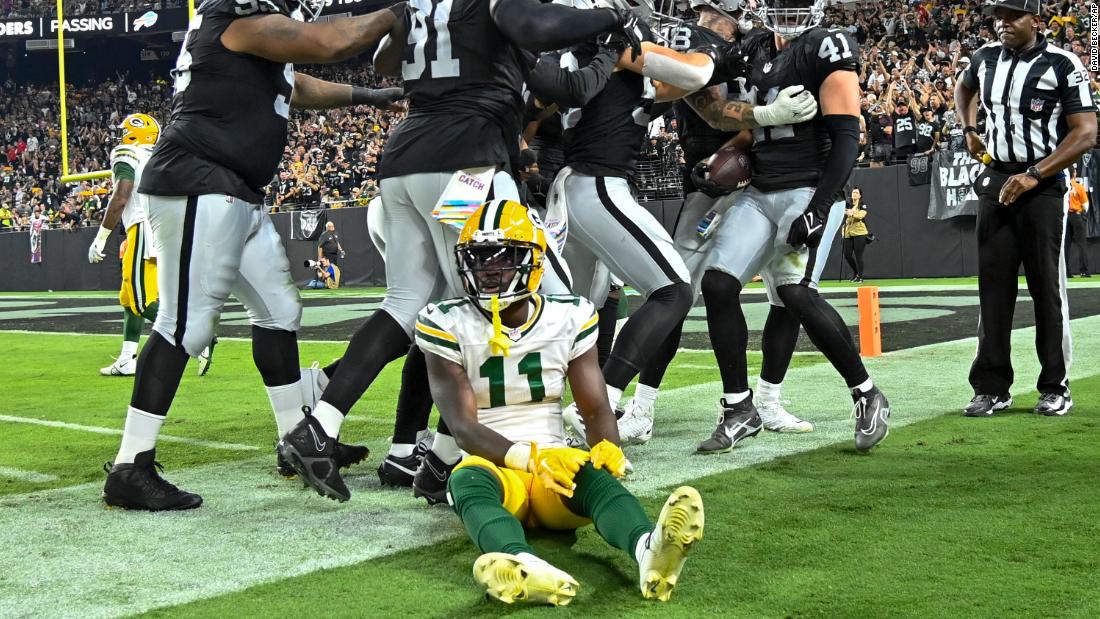 Green Bay Packers wide receiver Jayden Reed sits on the sideline as Las Vegas Raiders&#39; Robert Spillane is congratulated after his interception on Monday, October 9. The Raiders beat the Packers 17-13. 