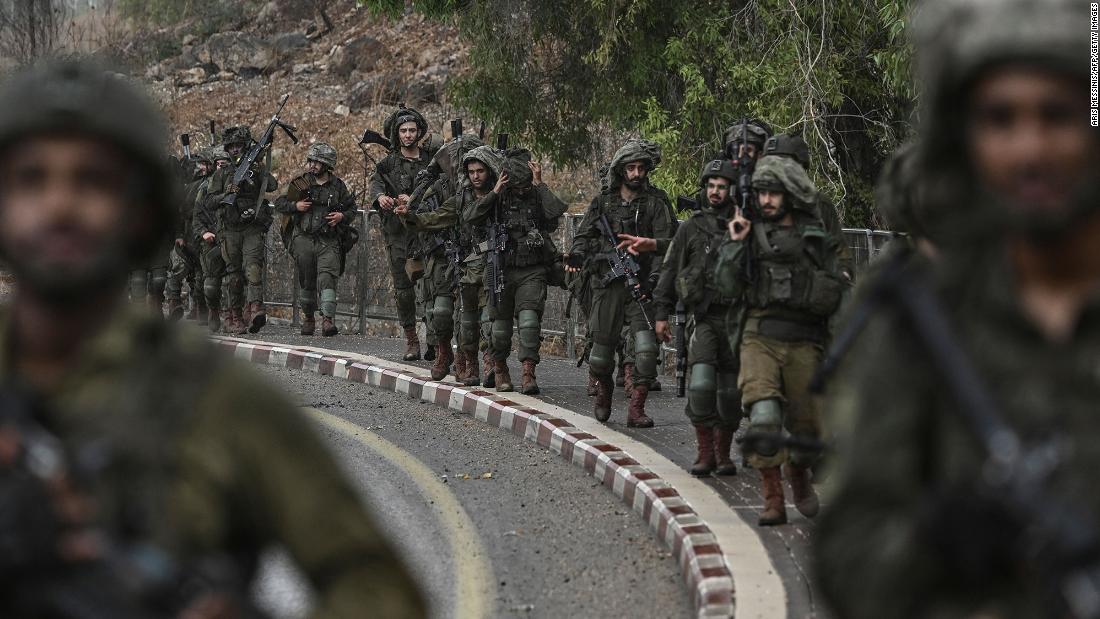Israeli army soldiers patrol at an undisclosed position in northern Israel near the border with Lebanon on October 15.