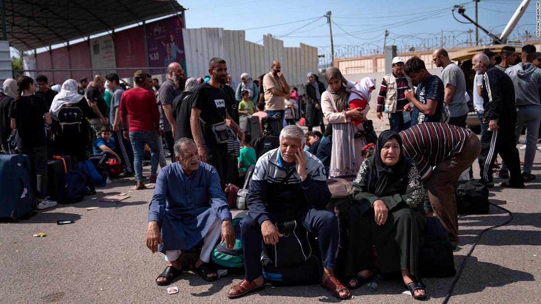 Palestinians wait to cross into Egypt at the Rafah border crossing in Gaza on October 16.
