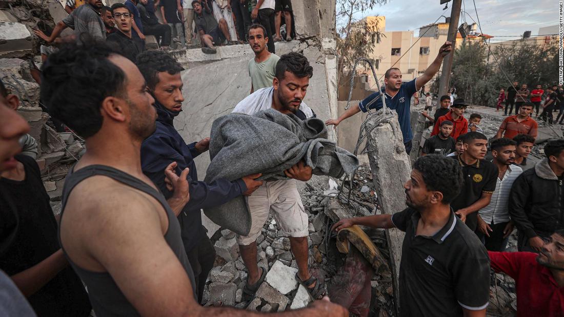 Civil defense members and residents conduct search and rescue operations amid destroyed buildings after an Israeli attack in Khan Younis, Gaza, on Tuesday, October 17,