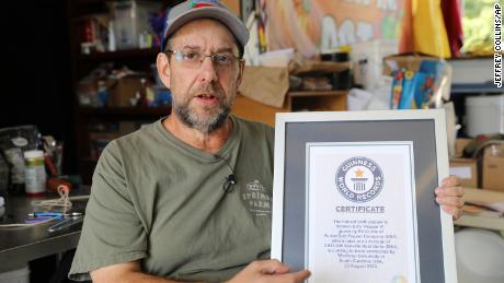 Ed Currie holds up certification that his new Pepper X variety of peppers is the hottest in the world, according to the Guinness Book of World Records