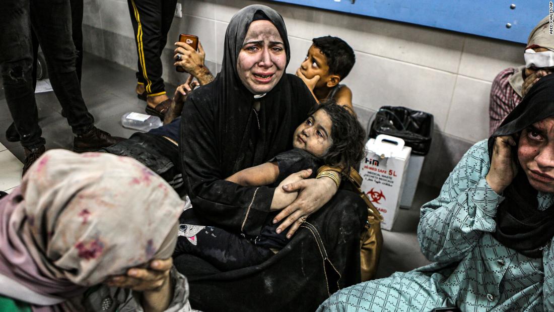 Wounded Palestinians sit on the floor at the Al-Shifa Hospital after being transported from the Al-Ahli Baptist Hospital following a blast there on Tuesday, October 17. 