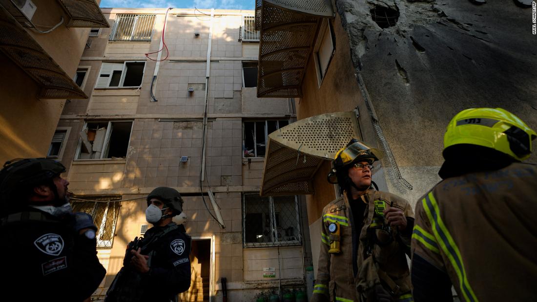 Israeli security forces inspect a damaged residential building after it was hit by a rocket fired from Gaza in Sderot, Israel on October 17.