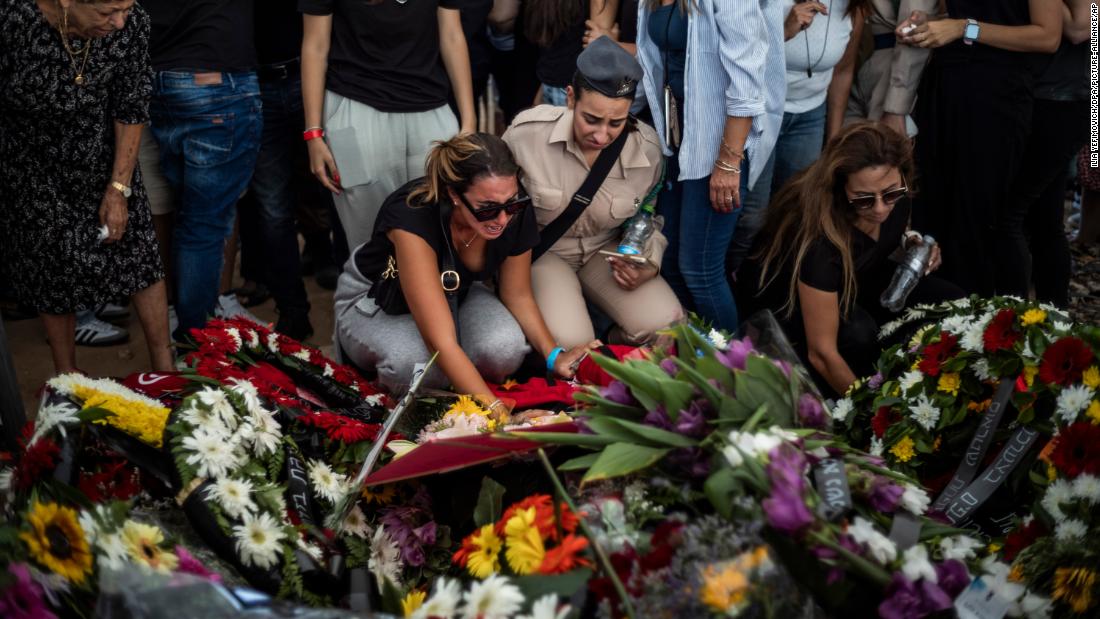 People lay wreaths during a funeral for the Israeli Kutz family in Gan-Yavne, Israel on October 17. The family of five were murdered in their home by Palestinian militants who infiltrated the Israeli Kibbutz of Kfar Aza last week.