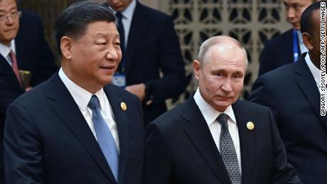 Chinese leader Xi Jinping and Russia&#39;s President Vladimir Putin head to a group photo session during the third Belt and Road Forum at the Great Hall of the People in Beijing on October 18.