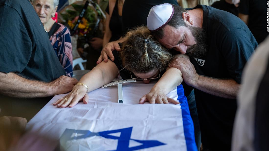 People mourn a family during a funeral in Hod HaSharon, Israel, on October 18.