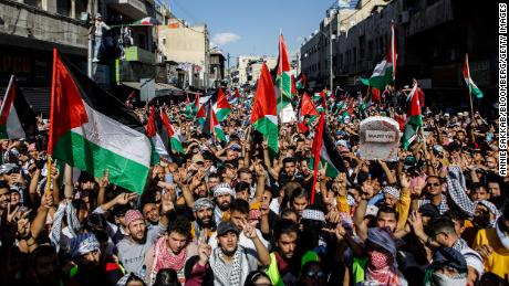 Protesters wave Palestinian flags during a pro-Palestinian demonstration in Amman, Jordan on Friday.
