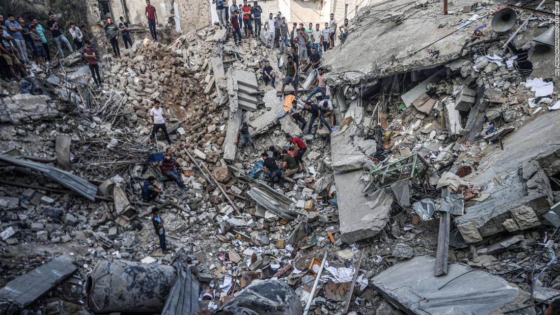 Civil defense teams and residents continue search and rescue efforts at a Greek Orthodox church after an Israeli airstrike in Gaza City on October 20.