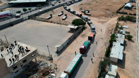 A convoy of lorries carrying humanitarian aid, including water, enters the Gaza Strip from Egypt via the Rafah border crossing on October 21, 2023.