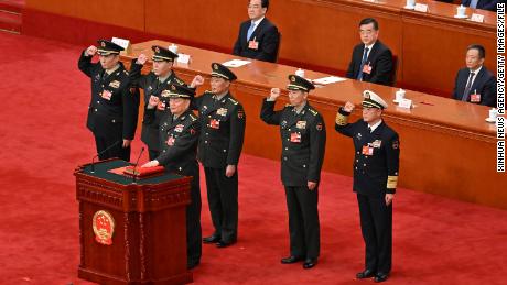 Vice chairmen and members of the Central Military Commissionof pledge allegiance to the Chinese constitution at the Great Hall of the People in Beijing on March 11.